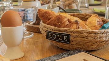 A breakfast table with bread, a cup, and a basket labeled "HOME".
