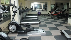 A gym with multiple treadmills, exercise bikes, and a mirrored wall. - Melka international hotel (Addis Ababa)
