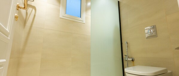 A bathroom with a toilet, a shower, and a window. - Kease Malqa F-3 Elegance AX44 (Riyadh)
