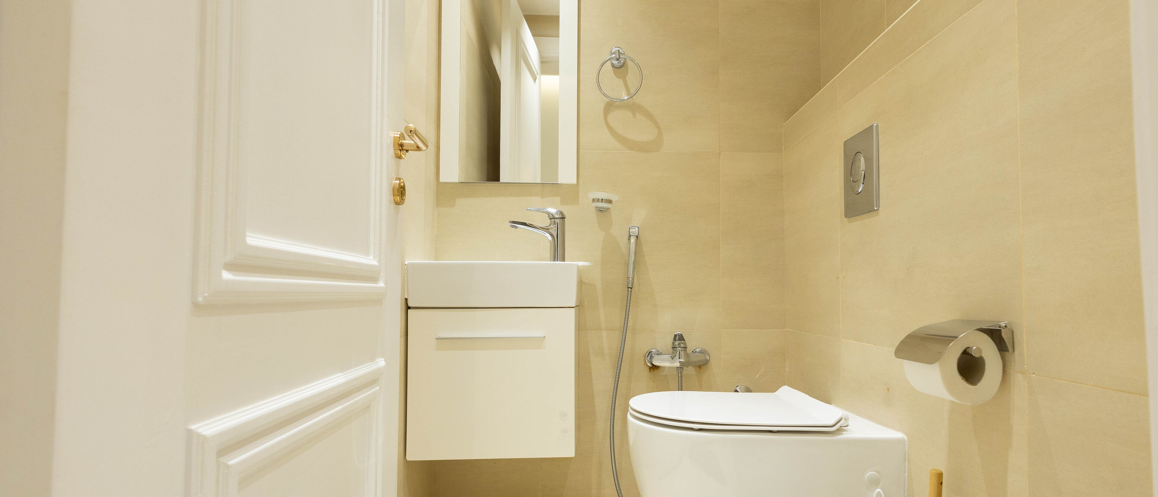 A bathroom with a toilet, sink, and shower.