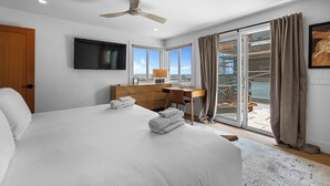 A hotel room with a bed, desk, and a view of the outside. - Partial Ocean Views/Walk to All/Great Location! (La Jolla)
