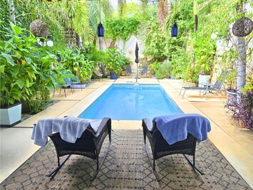 Beautiful garden and pool with ample seating.