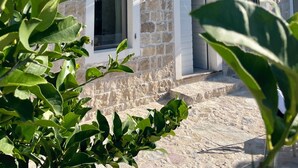A two-story stone building with balconies and windows. - Dreamlike stone house by the sea: luxury with infinity pool and panoramic views (Herceg Novi)