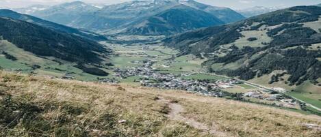 A mountainous landscape with a valley and a small town.