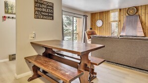 Una sala de estar acogedora con un banco de madera, un sofá y un reloj de pared.