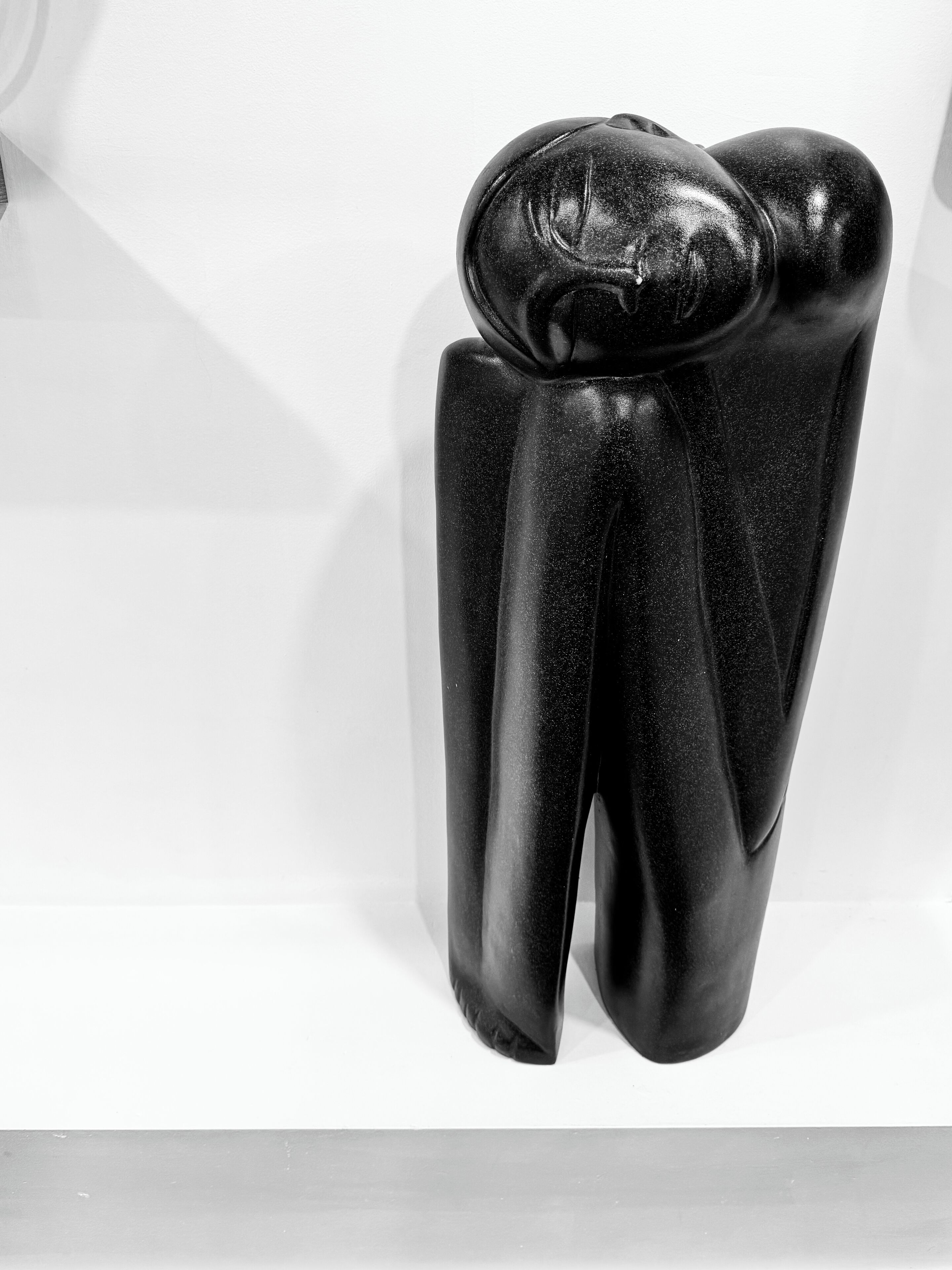 En svart, abstrakt skulptur som liknar en tand.