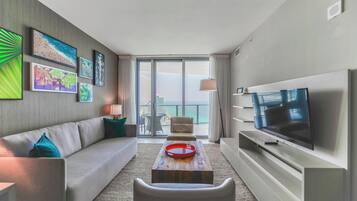 Deluxe Apartment, Partial Sea View | Living area | 50-inch Smart TV with cable channels