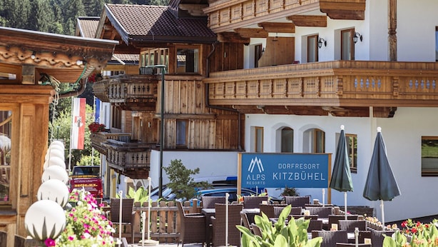 A traditional wooden building with a sign for 'Dorfresort Alps Kitzbühel'. - Ferienwohnung mit 2 Schlafzimmern fur 5 Personen (Reith bei Kitzbuehel)