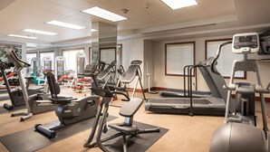 A gym with treadmills, elliptical machines, and weight equipment.