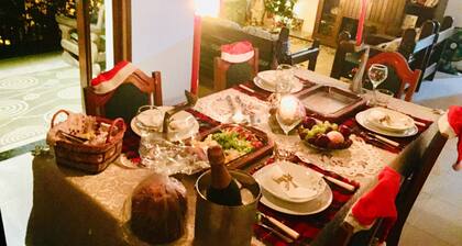 House in the mountains with pool and river.