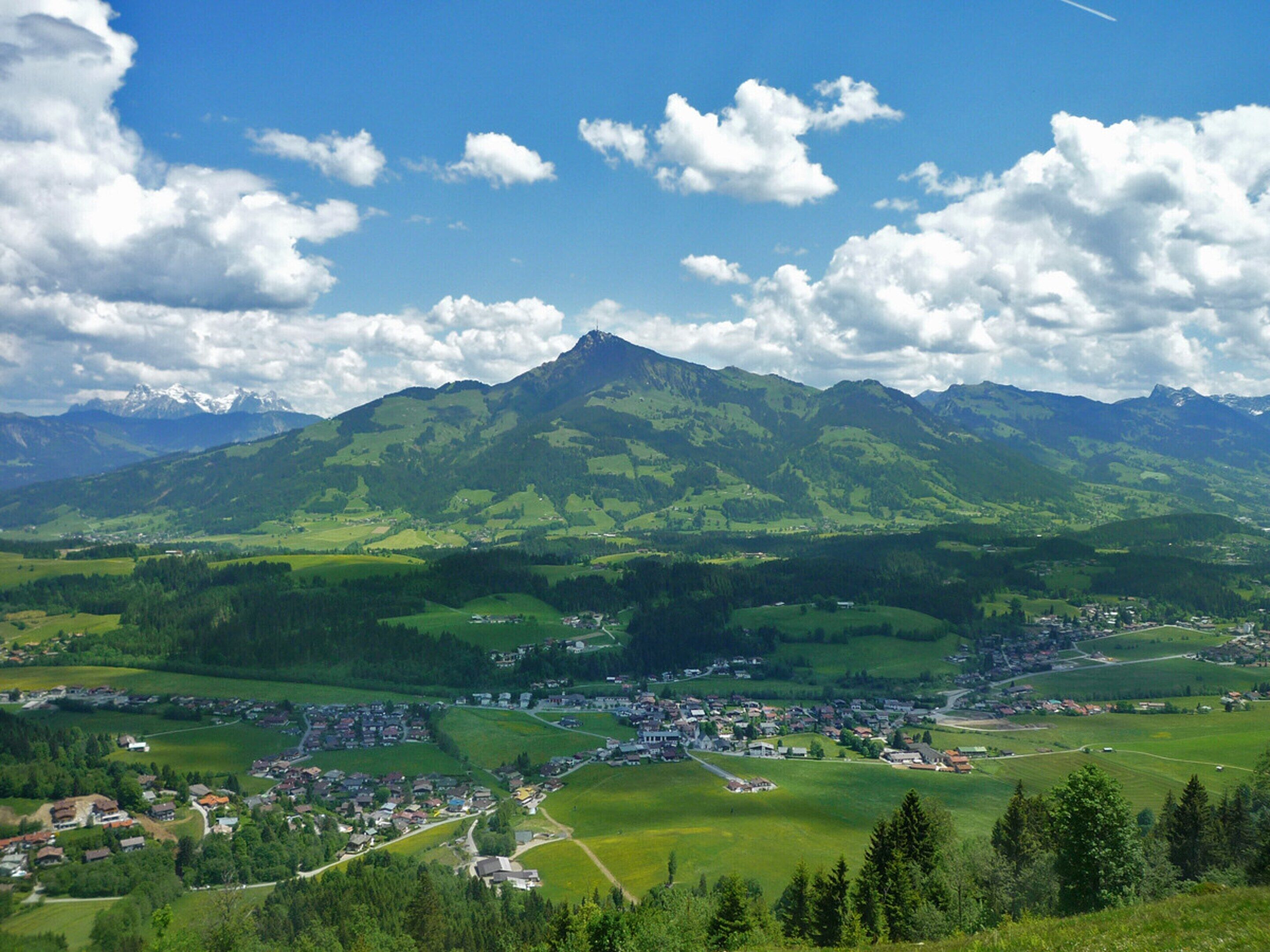 A mountainous landscape with a small town nestled in the valley.