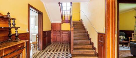 A staircase with wooden steps and a patterned floor.