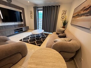 Luxury Apartment, City View | Living area | 55-inch Smart TV with digital channels
