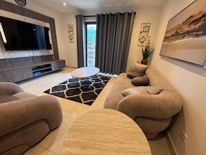 Luxury Apartment, City View | Living area | 55-inch Smart TV with digital channels