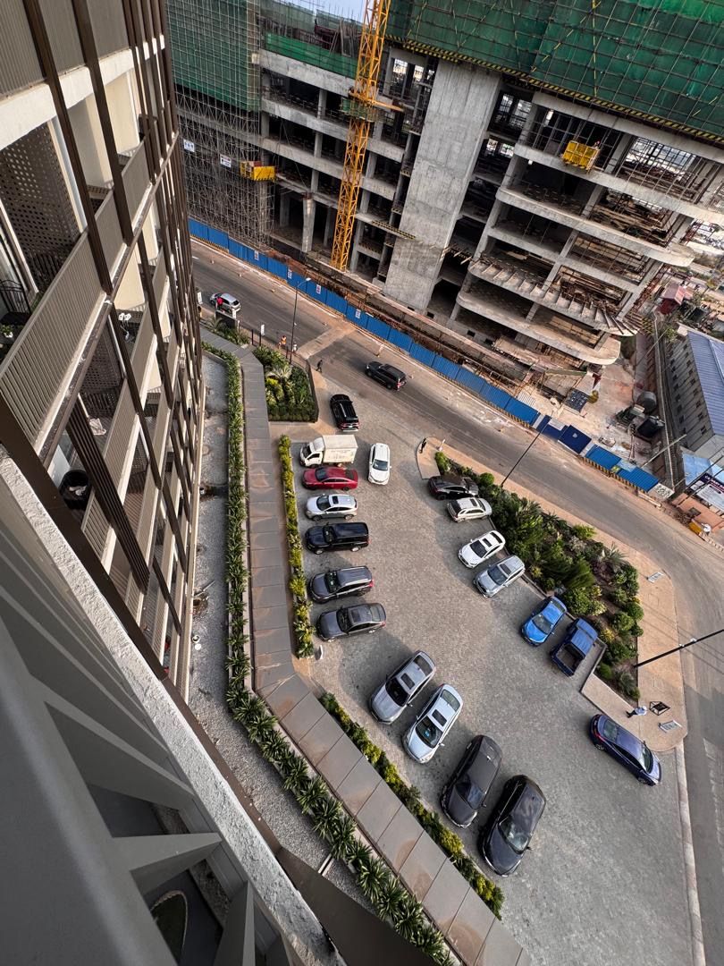 A multi-story parking structure with a variety of vehicles parked.