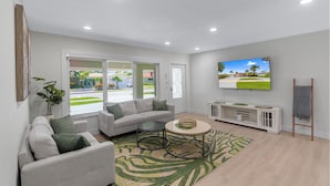 A modern living room with a sofa, coffee table, and TV.