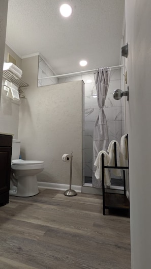 Shower, hair dryer, towels, toilet paper