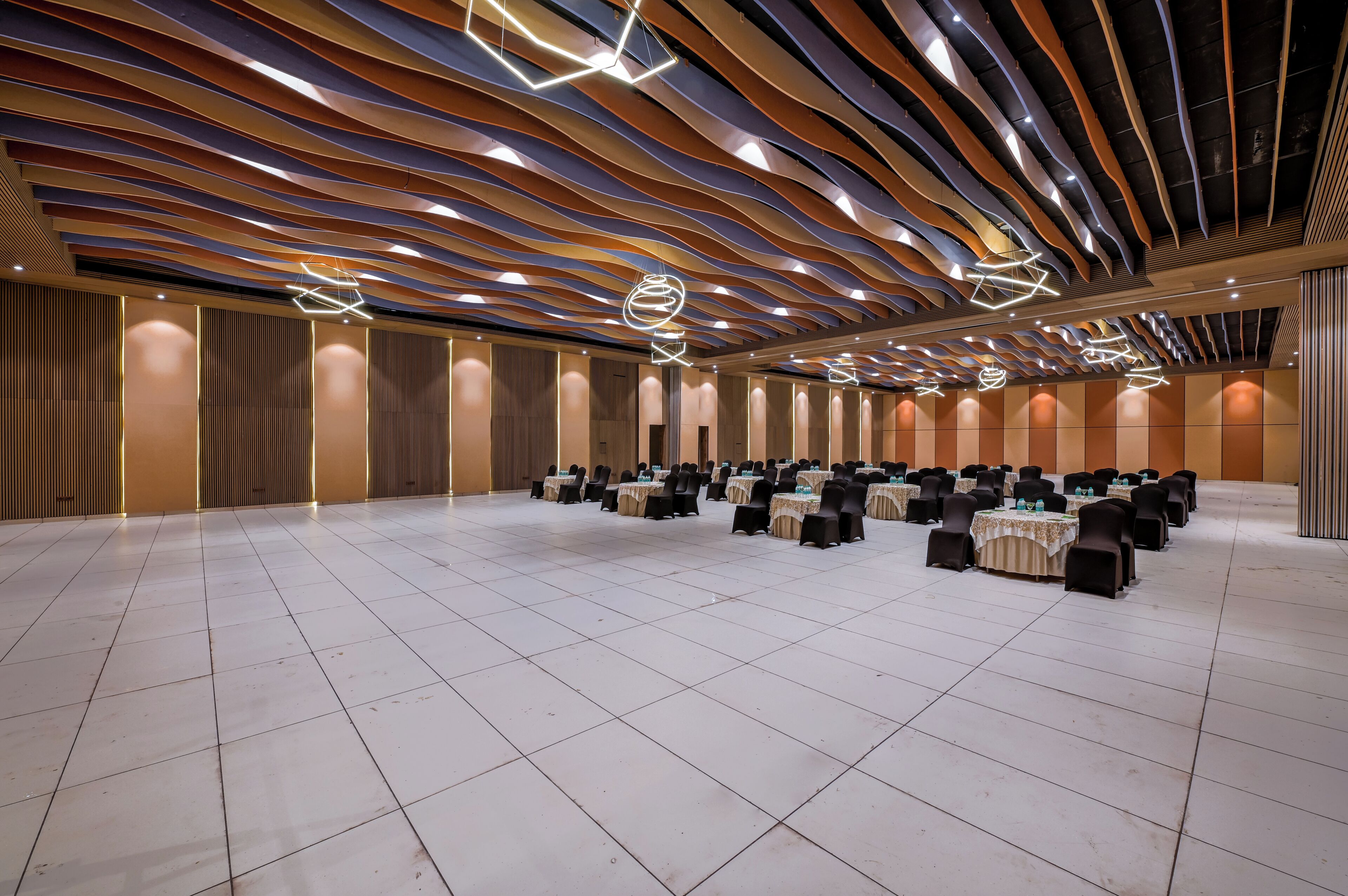 A spacious hall with tiered seating and modern lighting fixtures.