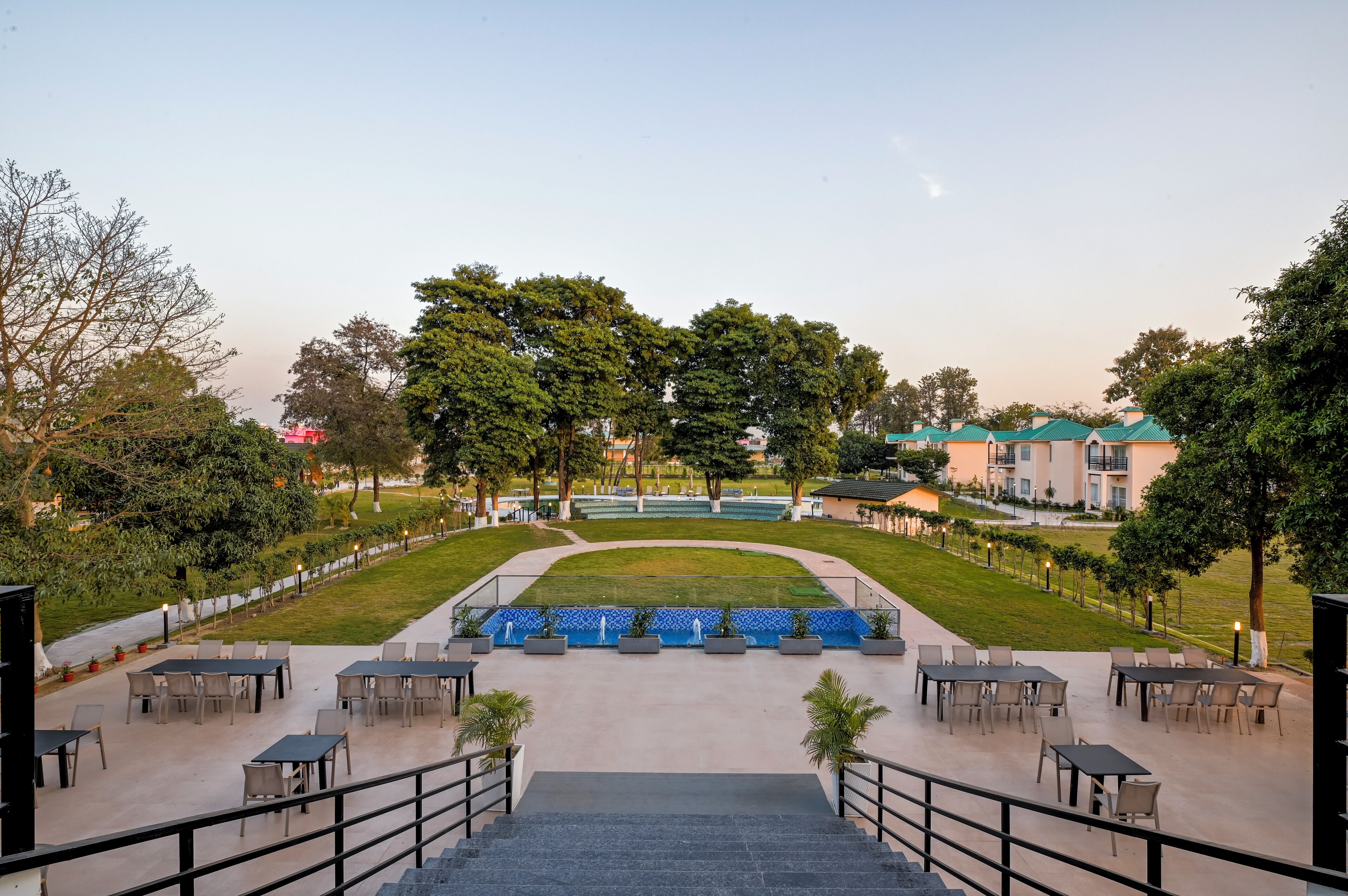 A courtyard with outdoor seating, a fountain, and a pool.