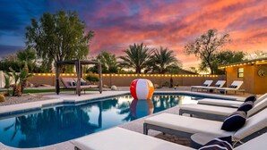 A pool area with lounge chairs, a pergola, and string lights. - Scottsdale Retreat | Pool & Spa | GameRoom (Scottsdale)