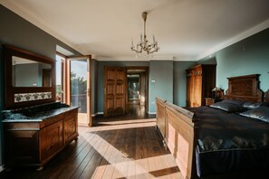 A spacious bedroom with a large bed, wooden wardrobe, and a mirror above the dresser. - Wine Estate on a Private Hill - Luxury with character for 15+ (Videm pri Ptuju)