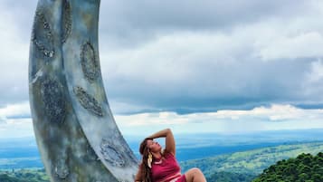Relax in a serene outdoor setting with a unique, crescent-shaped structure and breathtaking views of the surrounding landscape.