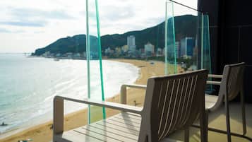 Enjoy breathtaking views of the beach and city from this balcony.