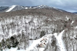 A snow-covered mountain landscape with a ski resort.