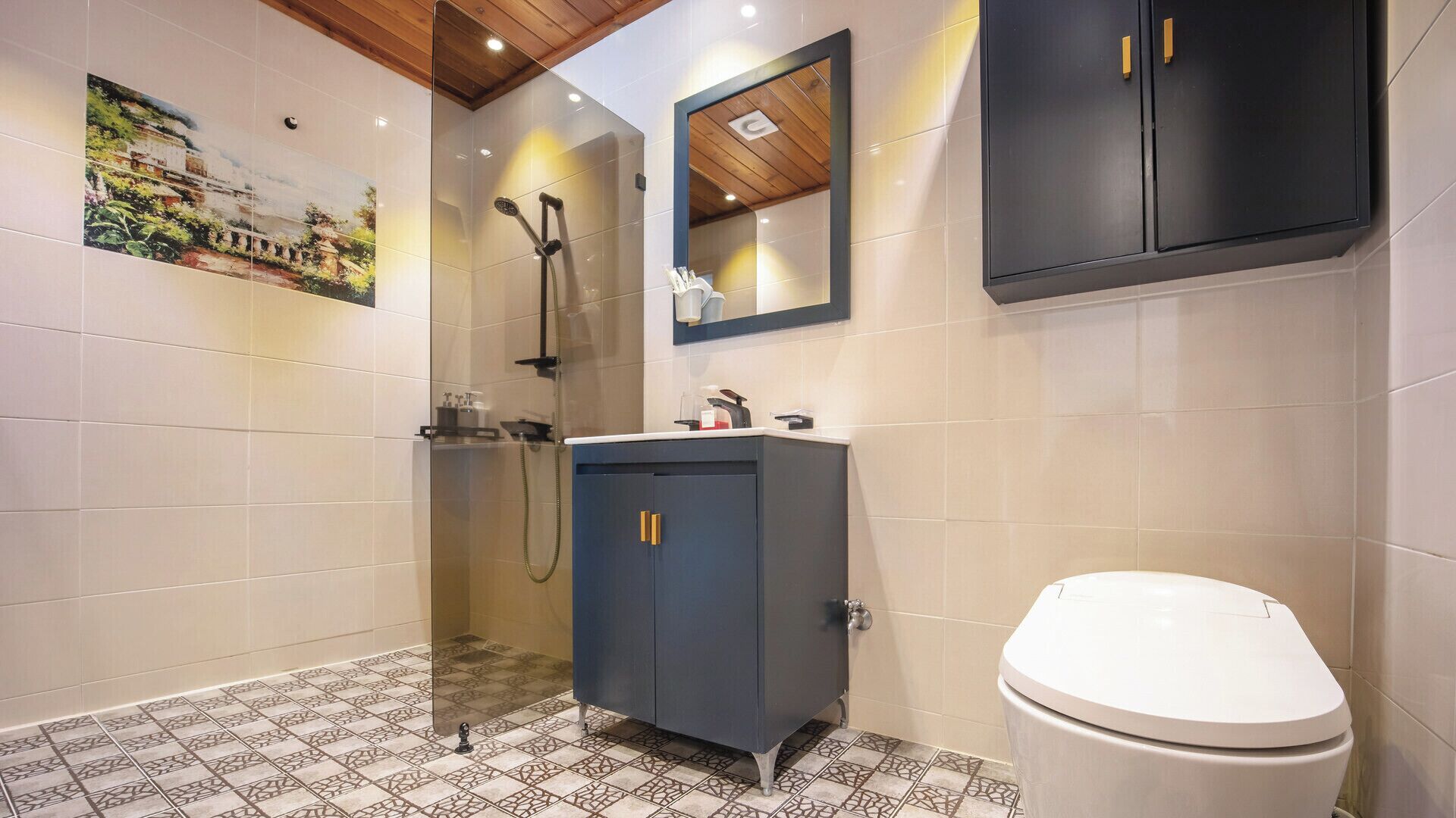 A modern bathroom with a shower, a sink, and a toilet.