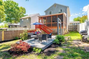 A backyard with a covered patio, outdoor furniture, and a barbecue grill. - Spacious 3-Bedroom, 1.5-Bath Home in Central Maryland with Screened Porch & More (Severn)