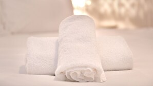 A neatly folded white towel on a bed. - Bright & Perfectly Located! - Pass the Keys (Cardiff)