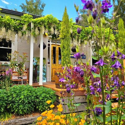 Cozy, beautifully decorated cottage sitting in a stunning seasonal garden 