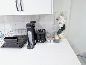 Enjoy cooking in this well-equipped kitchen with a coffee maker, toaster, and ample storage.