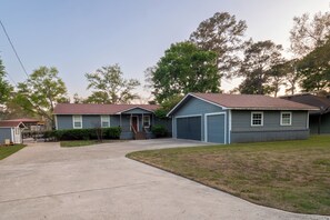 A residential area with houses, a driveway, and a lawn.