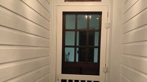 A white door with a small window and a decorative sign above it. - All one floor Charming large2 bedroom, LR, sunrm, kitchen, 1 Full & 1 half bath (Roaring Spring)