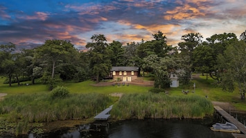 Sunset serenity at Whispering Pines—your private lakeside escape awaits.