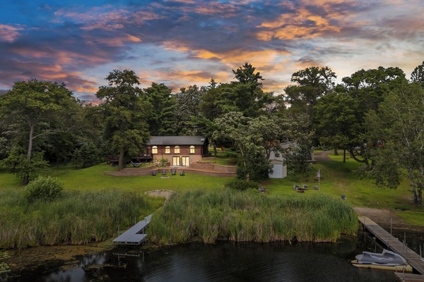 The sun sets over Perch Lake, Whispering Pines glows with warmth.