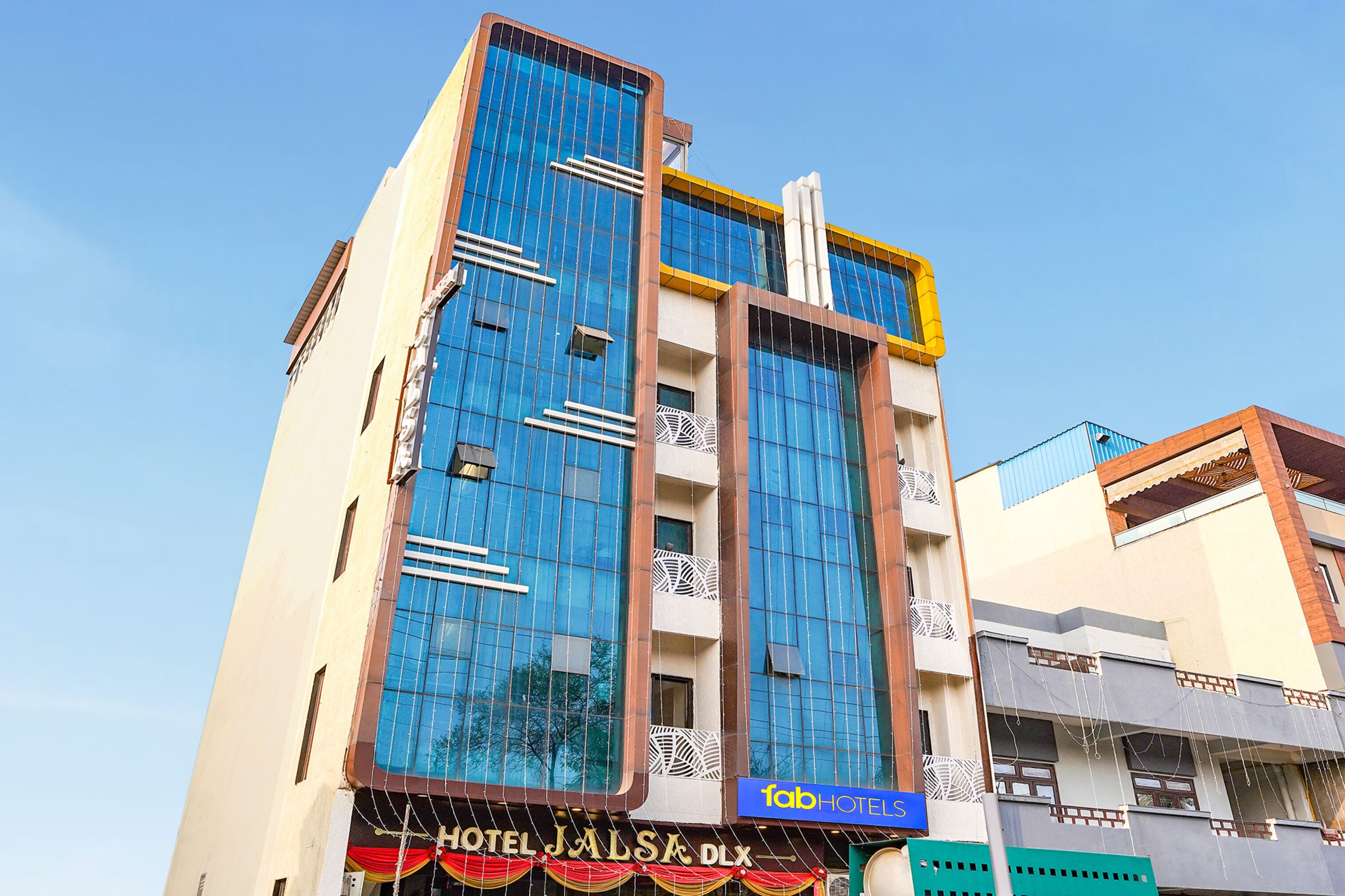 A hotel with a modern facade, large windows, and a sign indicating it is a hotel.