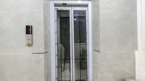 A modern elevator with a digital display showing the number 2. - Fabhotel Ssr Ikon Suites (Hyderabad)