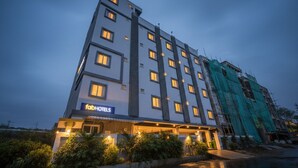 A multi-story hotel with a modern design, featuring a prominent 'fab hotels' sign at the ground level. - Fabhotel Ssr Ikon Suites (Hyderabad)