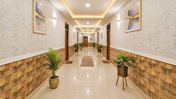 A hallway with a marble floor, potted plants, and framed artwork on the walls. - Fabexpress Ramayana Premium (Faizabad)