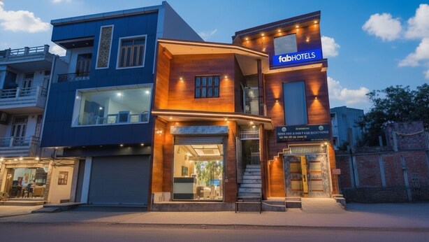 A modern building with a 'fabHOTELS' sign, featuring a glass entrance and a wooden facade. - Fabexpress Shree Siya Raman (Ayodhya)