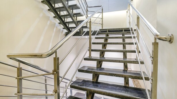 A set of metal stairs with handrails, leading to an upper floor. - Fabhotel Powai Inn (Mumbai)