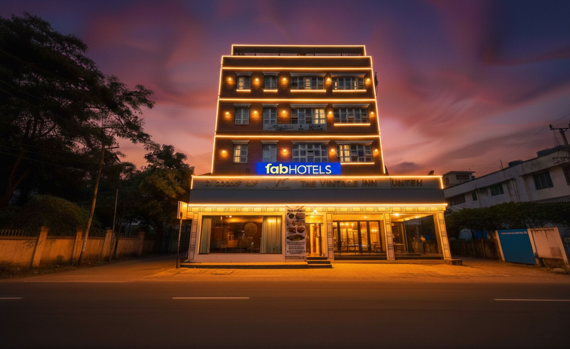 A multi-story hotel with a prominent sign reading "fabHOTELS".