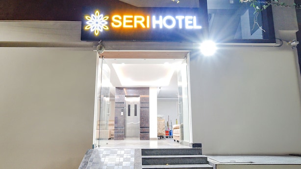 The entrance to SERI HOTEL with a clear glass door, a tiled floor, and a sign above the entrance. - Fabhotel Seri (Hyderabad)