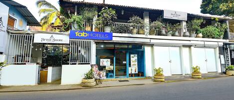 A hotel with a blue sign, a reception area, and a visible entrance.
