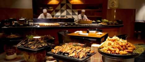 A buffet with various dishes, including seafood and fried items, in a restaurant setting.