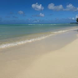 On the beach, white sand, sun-loungers, beach umbrellas