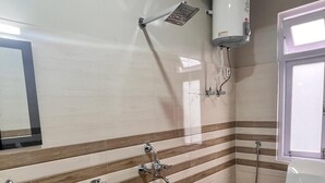 A bathroom with a sink, toilet, and shower. - Hotel Wanderlusts Rigyal Lachung (Chungthang)