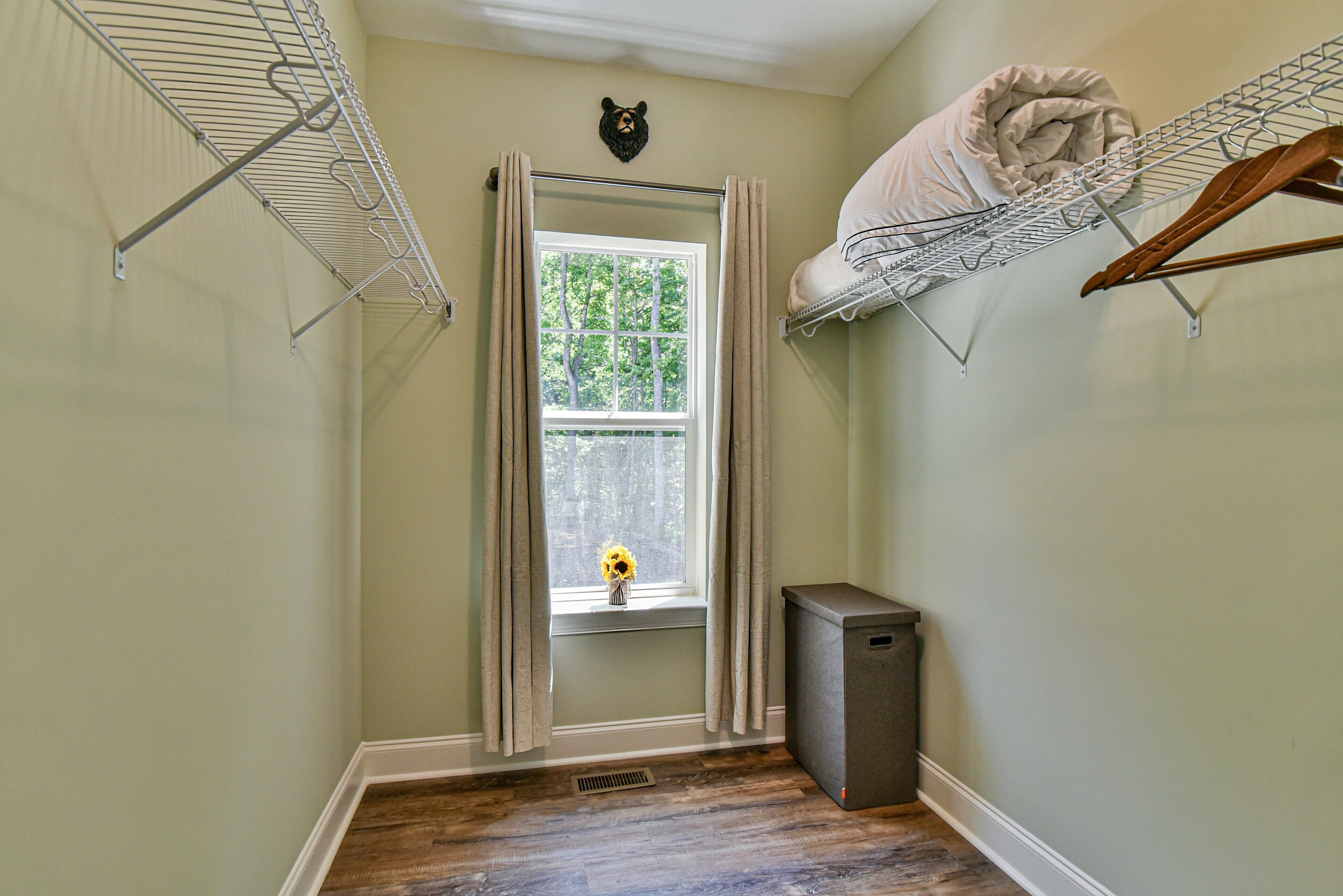 A laundry room with a window, a radiator, and a small heater.